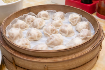 Xiao long bao soup dumpling buns with chopsticks in restaurant (Traditional Chinese food) in Taipei Taiwan