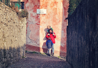 Mother with kids in Italy.