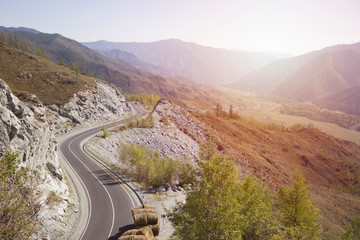 Road in mountain landscape with sunlight