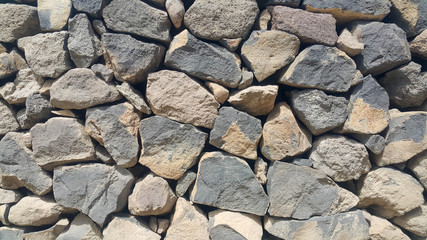 ancient wall of natural stones, fence, stones laid and fixed without concrete, very beautiful background