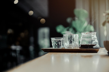 Coffee drip on wooden table , cafe background 