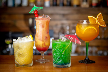 Multi-colored refreshing cocktails at the bar. Close up