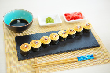 Sushi rolls on black slate surface. Japanese food Healthy and tasty food.