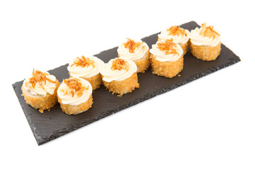 Fried sushi salmon sushimi on a black surface on white Healthy and tasty food.