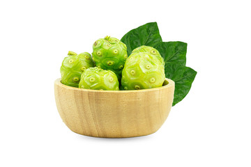 Noni or Morinda Citrifolia and pieces in a wooden cup, separate on a white background.