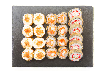 Japanese cuisine. Sushi with fresh ingredients over black background. Healthy and tasty food.