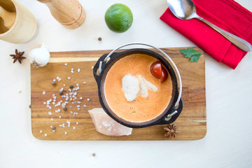 Fototapeta na wymiar Chicken Soup on a cutting board on a table