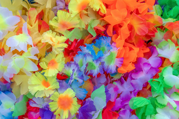 beautiful colors of plastic flowers.  colorful flowers can be used as a perfect background image. Decorative multicolored flowers. Abstract background of artificial flowers. View from above