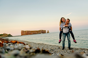 Fototapeta premium tourist couple enjoying Perce Rock view from Gaspe in Quebec