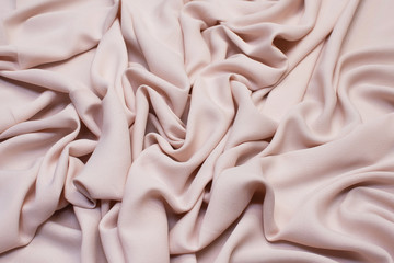 The texture of the synthetic fabric is pink. Background, pattern.