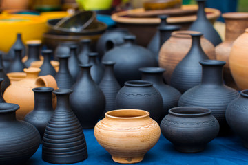 Fototapeta na wymiar Clay vessels of different colors. Ceramics
