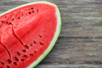 Fresh ripe watermelon on a wooden table, background on the theme of wholesome eating with space for text