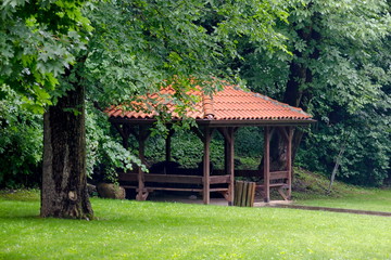 Fototapeta na wymiar Big alcove and benches on the park Rila in rainy day near town Dupnitsa, Bulgaria 
