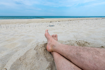 2 feet stretch out on a beach at the German Baltic Sea