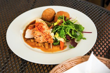 Roasted chicken breast, croquettes and salad.