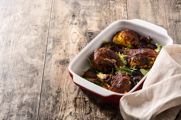 Roasted tandoori chicken with basmati rice on wooden table. Copyspace