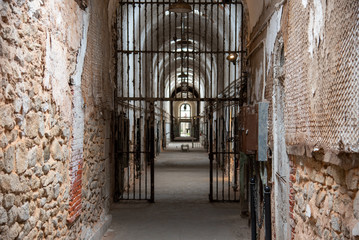 Prison corridor with cells on both sides - obrazy, fototapety, plakaty