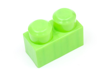 Green plastic building block isolated on white background. Developmental toys for children.
