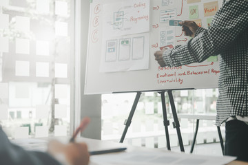 user experience UX designer designing web on smart phone layout. UI developer planning working on...