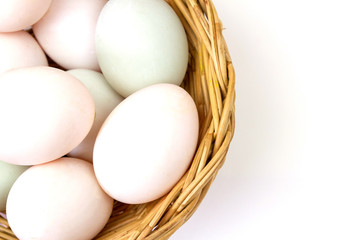 Fresh white eggs in basket isolated on white background.