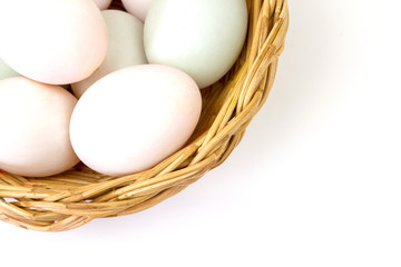 Fresh white eggs in basket isolated on white background.