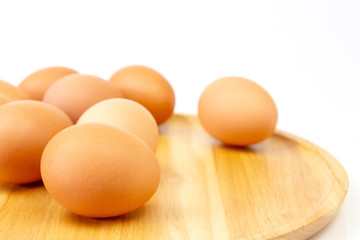 Fresh brown eggs on wooden isolate white background.