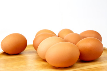 Fresh brown eggs on wooden isolate white background.