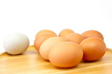 Fresh brown eggs on wooden isolate white background.