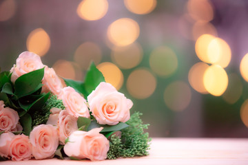 Rose flower on wooden table with blur bokeh background
