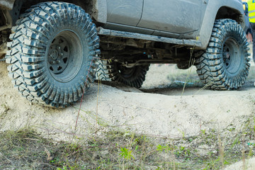 Fototapeta na wymiar Off-road dirty car wheels. Swamp rubber. Jeep in the swamp. Trial competition.