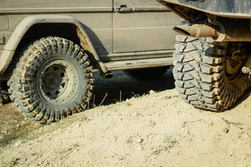 Fototapeta na wymiar Off-road dirty car wheels. Swamp rubber. Jeep in the swamp. Trial competition.