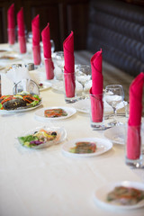 Table in the restaurant with appliances ready for the beginning of dinner