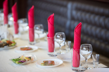 Table in the restaurant with appliances ready for the beginning of dinner