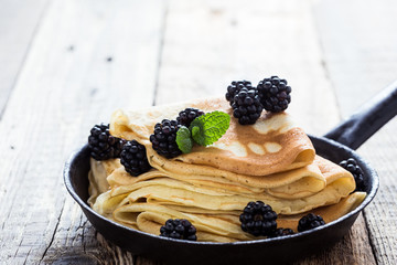 Morning meal, homemade crepes, fresh summer blackberries