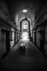 Prison corridor with cells on both sides - obrazy, fototapety, plakaty