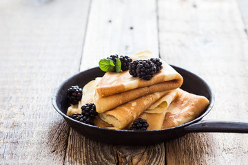 Morning meal, homemade crepes, fresh summer blackberries