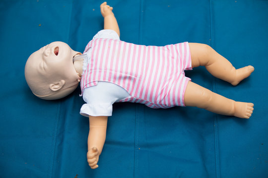 Mannequin child for first aid training. Training dummy kid for practicing artificial respiration