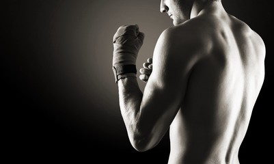 Fototapeta na wymiar Portrait of a handsome man boxing isolated on background