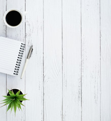 White wooden office desk table with coffee cup and blank notebook, Sticky note and supplies, Top view with copy space, work space, flat lay