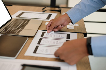 user experience UX designer designing web on smart phone layout. UI developer planning working on mobile application prototype
