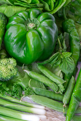 Healthy green vegetables: broccoli and cucumbers, lettuce, onions and peppers.