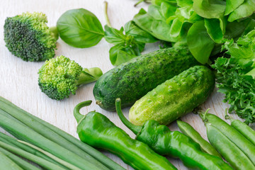 Healthy green vegetables: broccoli and cucumbers, lettuce, onions and peppers.