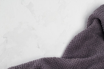 Frame from gray towel on white concrete background. Close-up, flat lay, copy space
