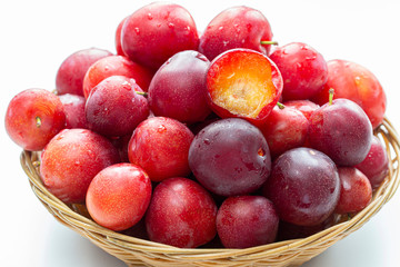A lot of plums closeup on a white background