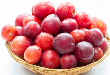 A lot of plums closeup on a white background