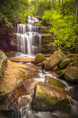 Gorgeous springtime waterfall in the mountains of North Carolina showing the green foliage.