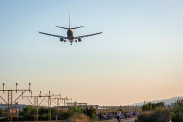 Fototapeta na wymiar airplane landing at sunset - image