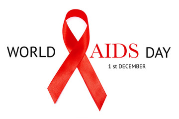 World AIDS Day inscription on white background and Red ribbon as the global symbol for solidarity with HIV people and those living with AIDS