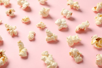 Flat lay composition with popcorn on pink background, closeup
