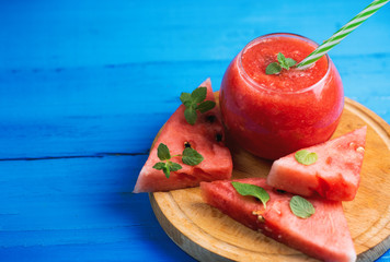 Fresh watermelon smoothie on wooden blue background .